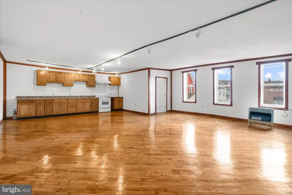 a view of empty room with wooden ceiling