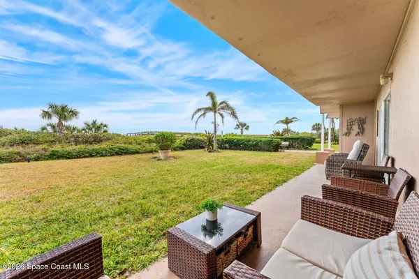 a view of a ocean with couches and city view