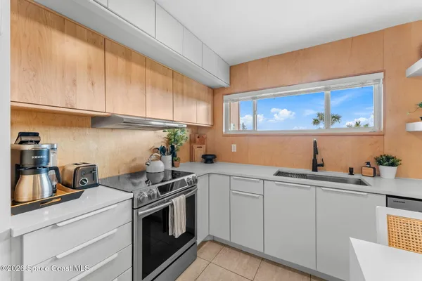 a kitchen with a sink cabinets and appliances