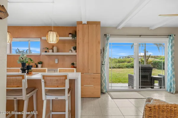 a kitchen with a table chairs and a window