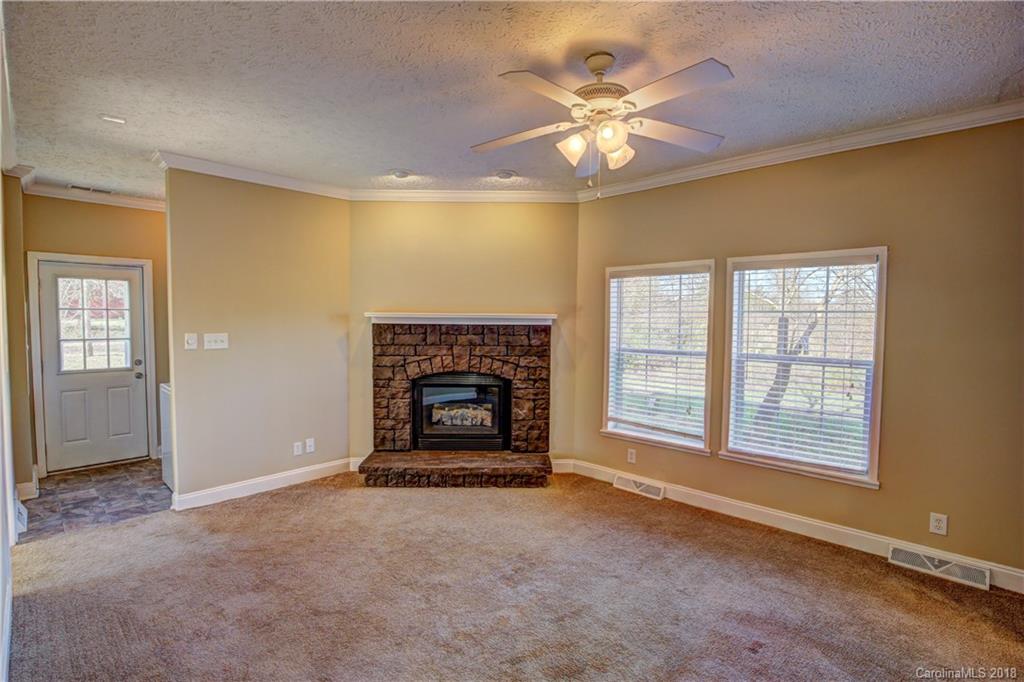 2006 Long Hope Road Monroe, NC 28112 - Photo 14 of 34 an empty room with chandelier fan and windows