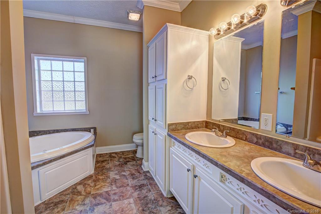 2006 Long Hope Road Monroe, NC 28112 - Photo 18 of 34 a bathroom with a granite countertop tub sink and mirror