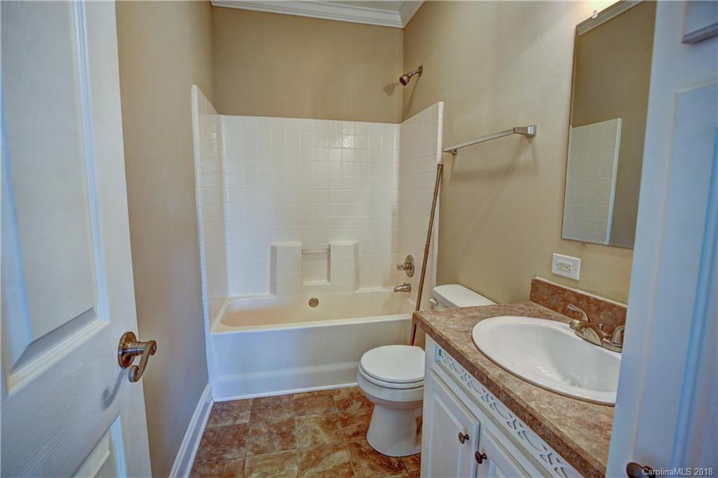 2006 Long Hope Road Monroe, NC 28112 - Photo 26 of 34 a bathroom with a granite countertop toilet a sink and a bathtub