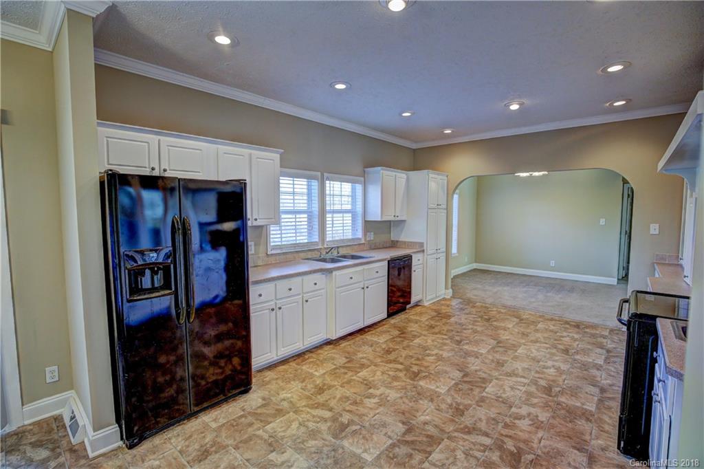 2006 Long Hope Road Monroe, NC 28112 - Photo 8 of 34 a large kitchen with stainless steel appliances a large counter top and a refrigerator