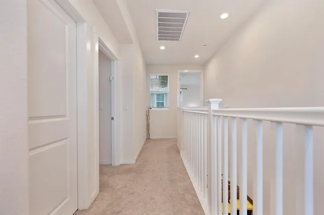 a view of a hallway with wooden floor and entryway