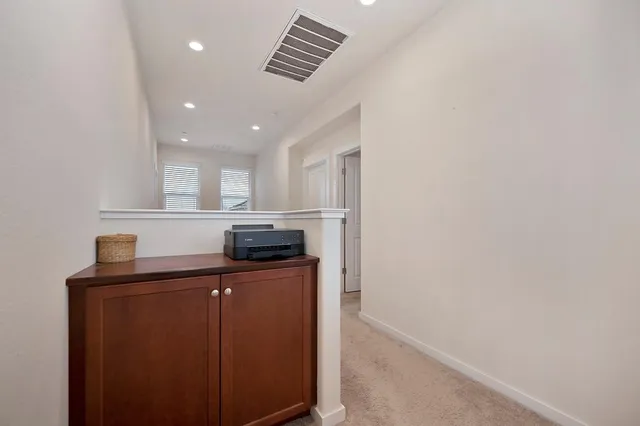 a kitchen with stainless steel appliances granite countertop a sink and a refrigerator
