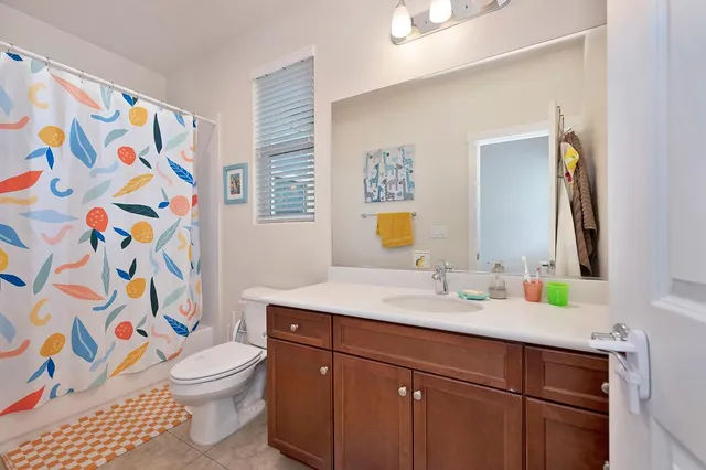 a bathroom with a sink toilet and a mirror
