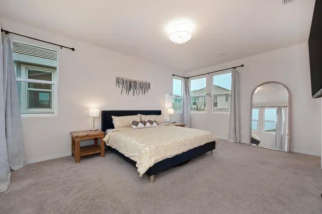 a spacious bedroom with a bed and window