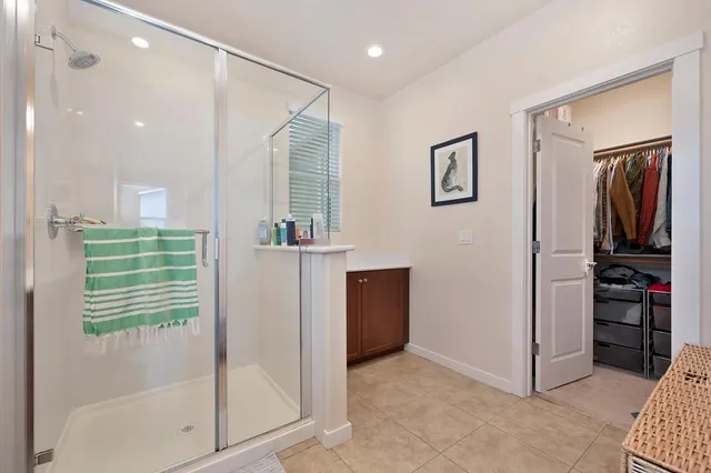 a view of hallway with walk in closet and bathroom