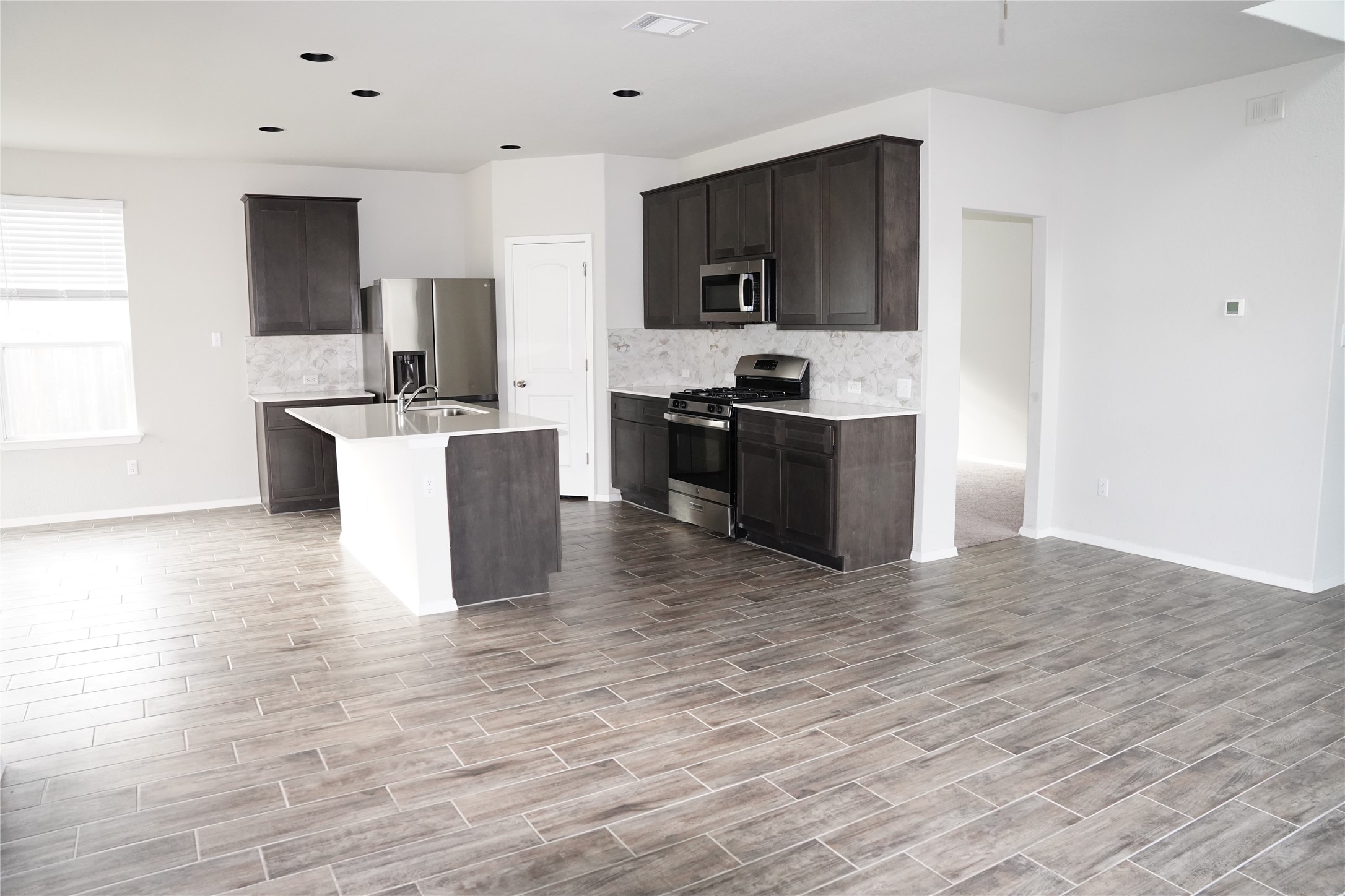 117 Crescent Street Georgetown, TX 78626 - Photo 11 of 38 A well-appointed kitchen and living space, offering an inviting atmosphere for daily living.