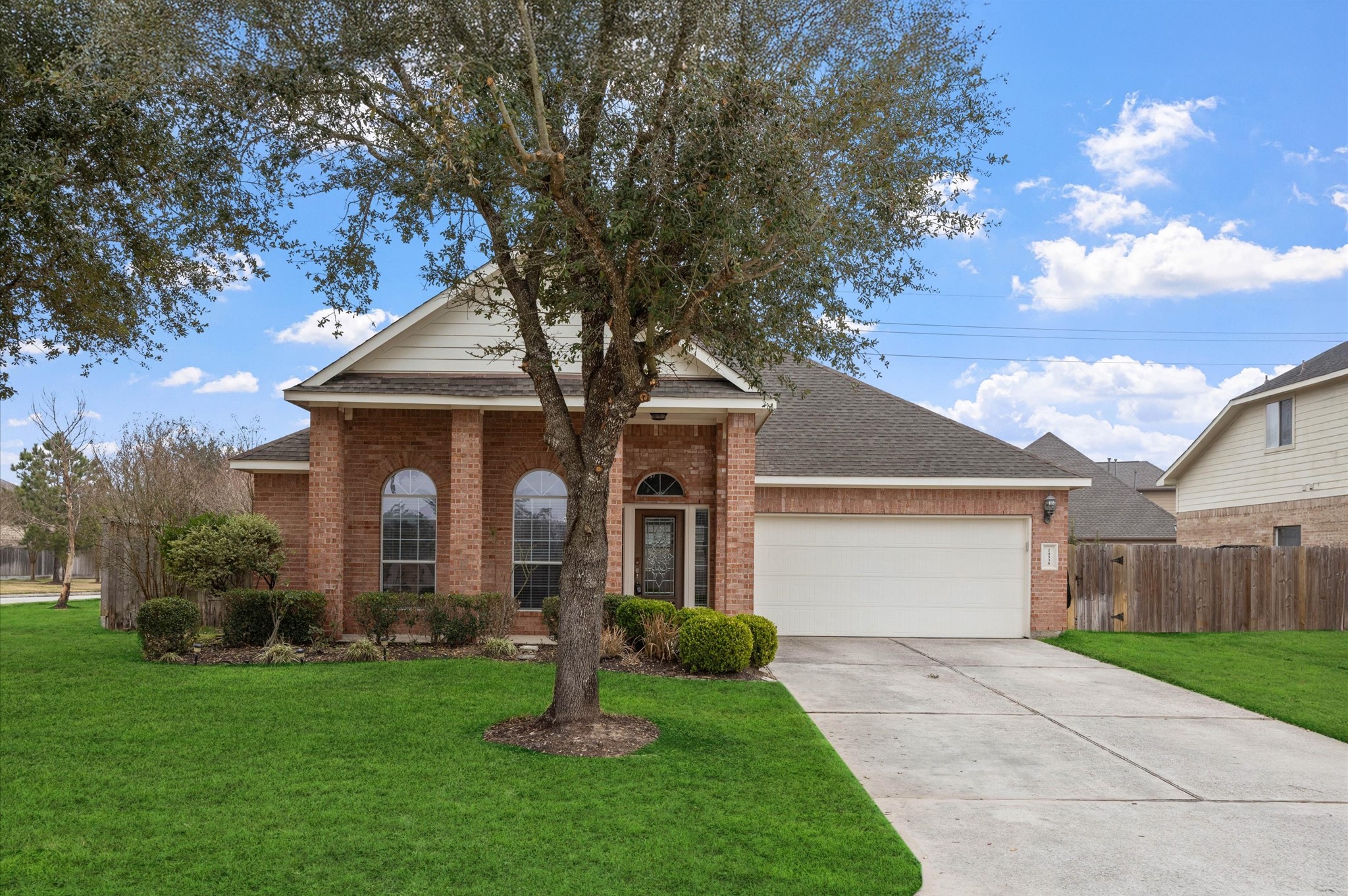 24538 Fort Settlement Drive Spring, TX 77373 - Photo 4 of 29 Charming brick home with a welcoming front porch, featuring a well-maintained lawn and mature trees. It includes a spacious driveway leading to a two-car garage. Perfect for families seeking a cozy neighborhood setting.