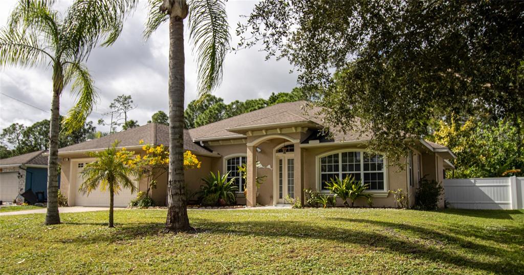 2817 Parrot Street North Port, FL 34286 - Photo 1 of 1 a front view of a house with a garden