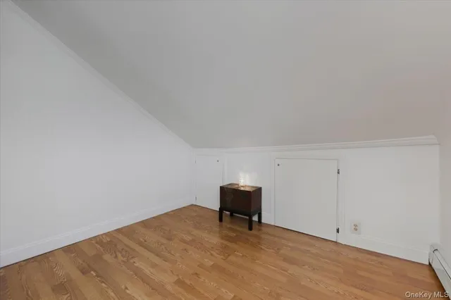 a view of room with wooden floor and white walls