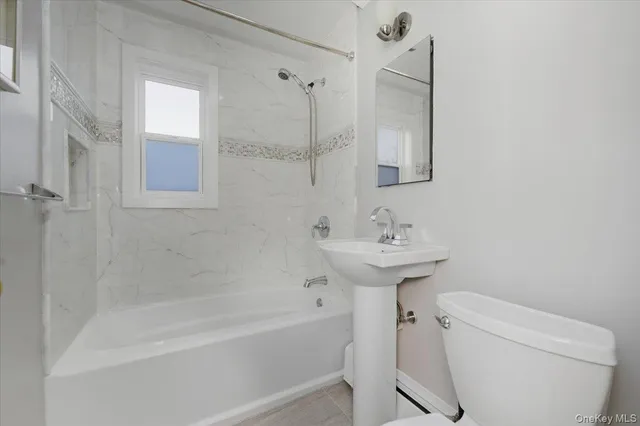 a bathroom with a sink a toilet and bathtub