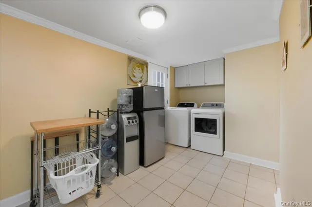 a view of a kitchen with fridge and workspace