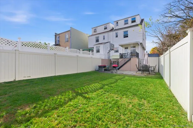 a view of a house with a big yard and a large tree