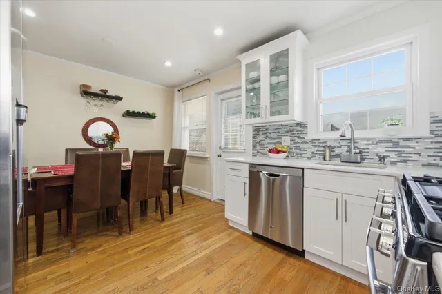 a kitchen with kitchen island granite countertop a sink cabinets and wooden floor