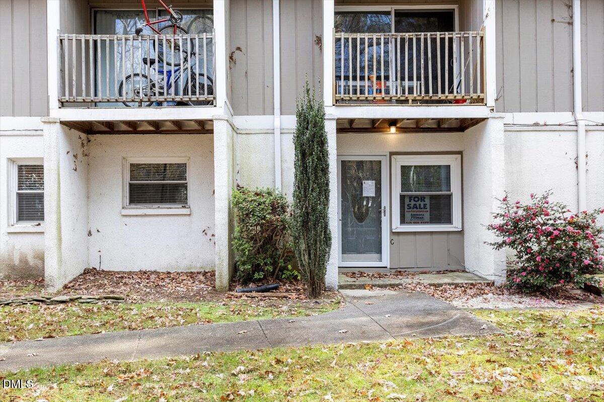 7124 Longstreet Drive, Unit C Raleigh, NC 27615 - Photo 1 of 27 a front view of a house with a yard
