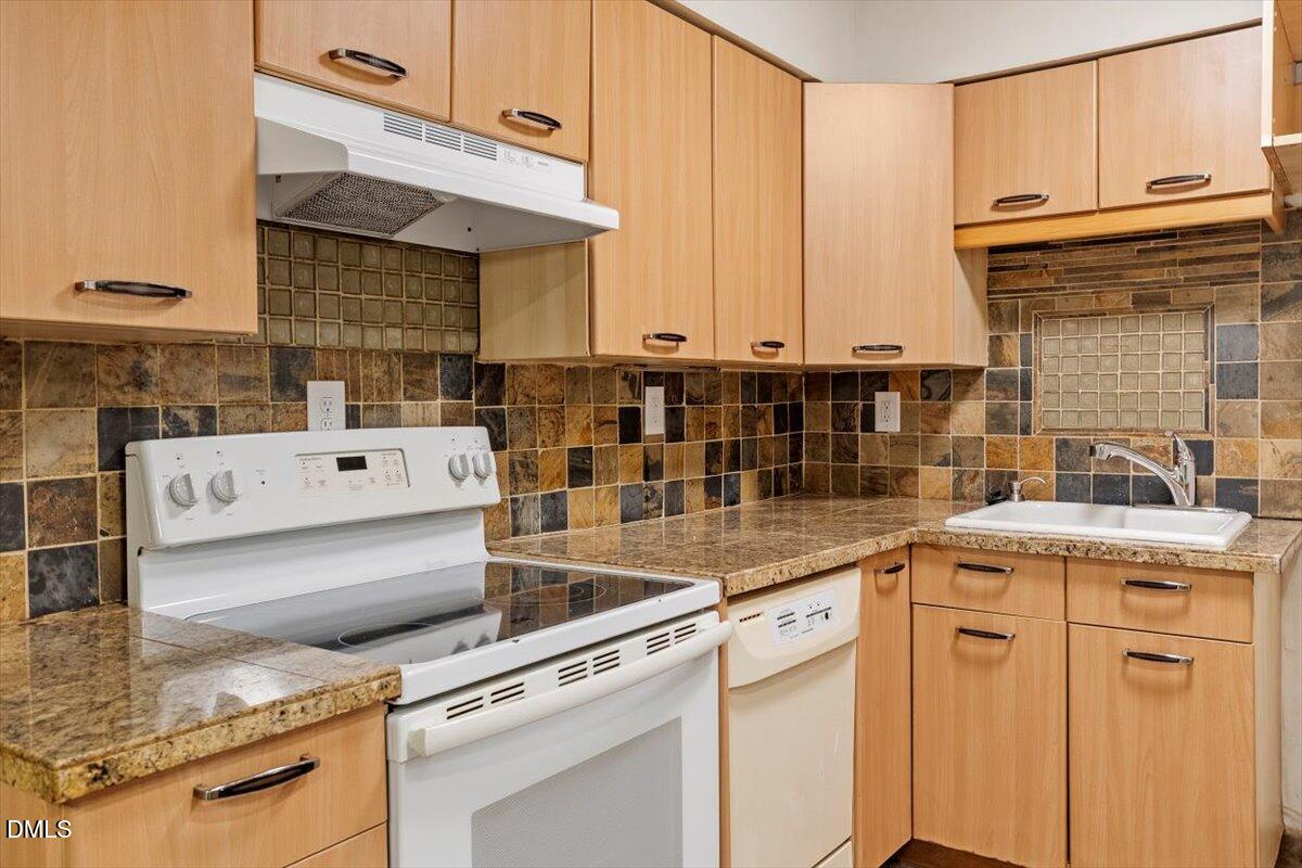 7124 Longstreet Drive, Unit C Raleigh, NC 27615 - Photo 12 of 27 a kitchen with a sink stove and cabinets