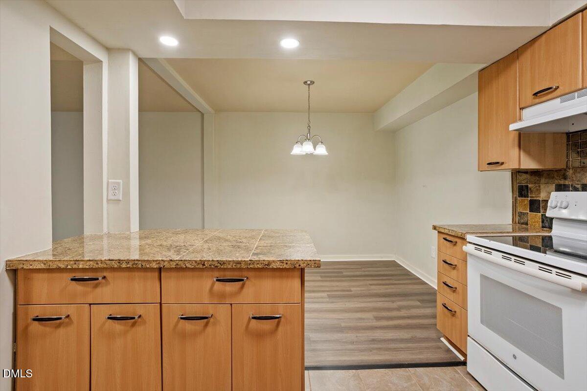 7124 Longstreet Drive, Unit C Raleigh, NC 27615 - Photo 14 of 27 a kitchen with a sink and a stove top oven