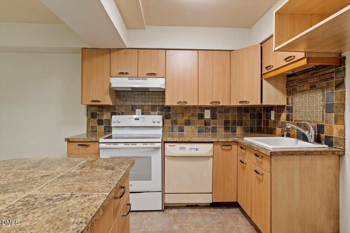 7124 Longstreet Drive, Unit C Raleigh, NC 27615 - Photo 15 of 27 a kitchen with a stove top oven sink and cabinets