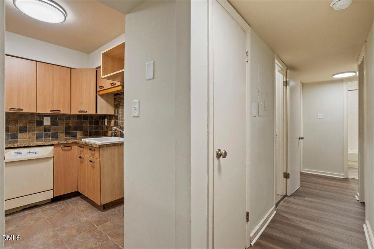 7124 Longstreet Drive, Unit C Raleigh, NC 27615 - Photo 16 of 27 a kitchen with white cabinets and sink