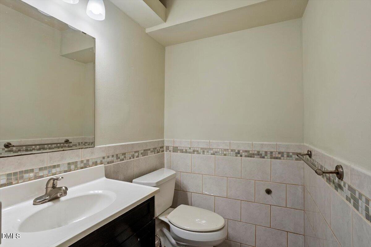 7124 Longstreet Drive, Unit C Raleigh, NC 27615 - Photo 19 of 27 a bathroom with a sink a toilet and shower