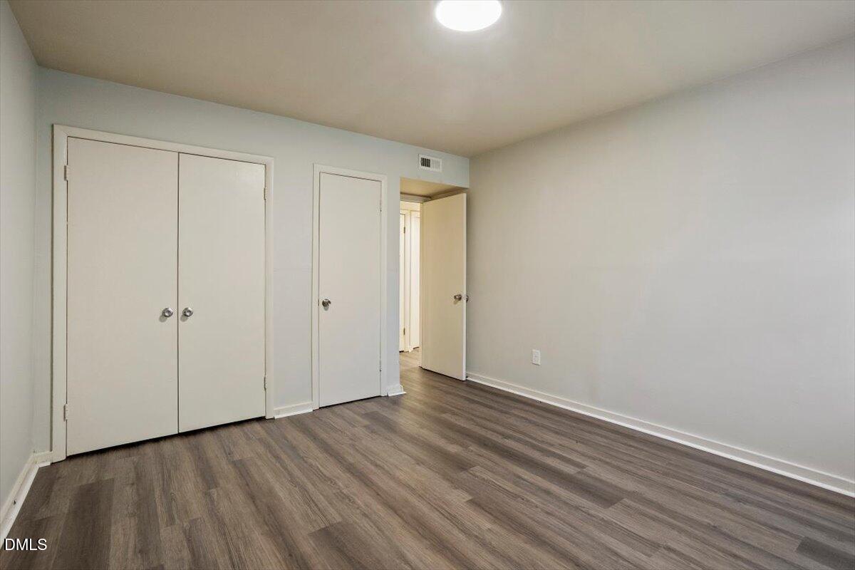 7124 Longstreet Drive, Unit C Raleigh, NC 27615 - Photo 21 of 27 a view of an empty room with wooden floor