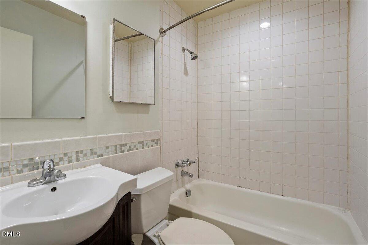 7124 Longstreet Drive, Unit C Raleigh, NC 27615 - Photo 22 of 27 a bathroom with a sink toilet and shower