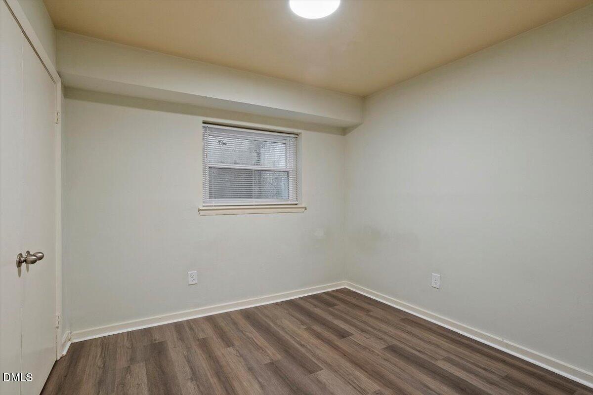 7124 Longstreet Drive, Unit C Raleigh, NC 27615 - Photo 24 of 27 a view of an empty room with wooden floor and a window