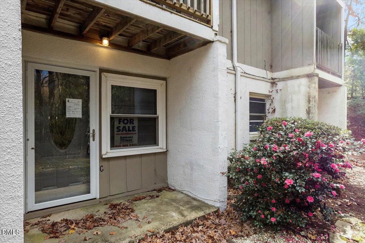 7124 Longstreet Drive, Unit C Raleigh, NC 27615 - Photo 3 of 27 a view of a porch with a potted plant