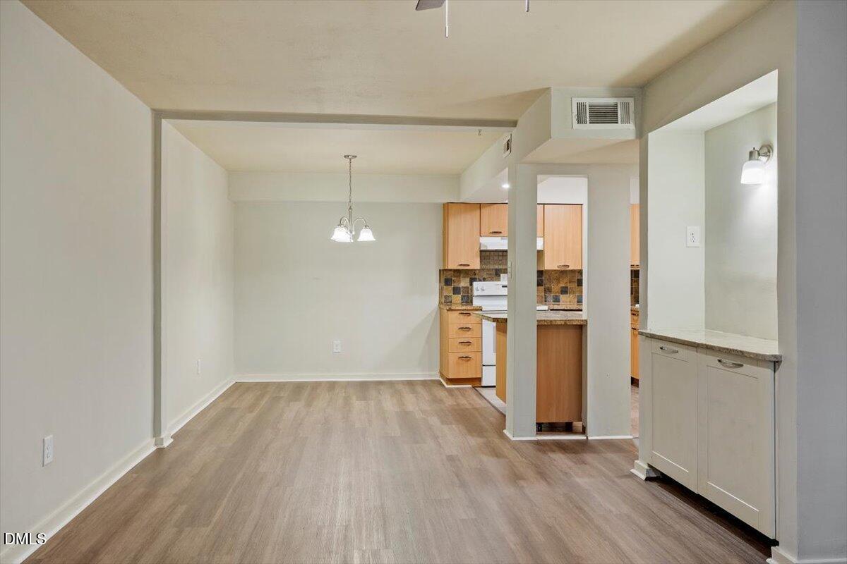 7124 Longstreet Drive, Unit C Raleigh, NC 27615 - Photo 4 of 27 a view of a kitchen with wooden floor