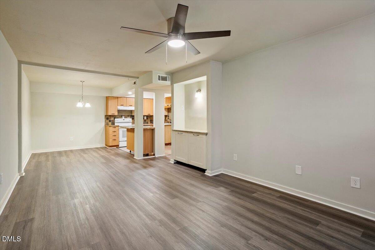 7124 Longstreet Drive, Unit C Raleigh, NC 27615 - Photo 5 of 27 wooden floor in an empty room with a window