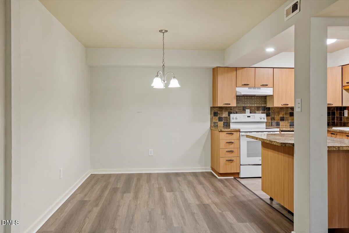 7124 Longstreet Drive, Unit C Raleigh, NC 27615 - Photo 9 of 27 a view of a kitchen with stove and refrigerator