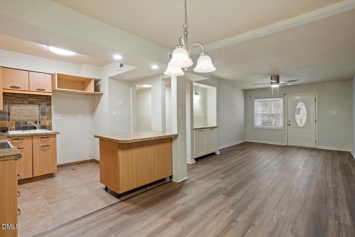 7124 Longstreet Drive, Unit C Raleigh, NC 27615 - Photo 10 of 27 a open kitchen with stove and white cabinets