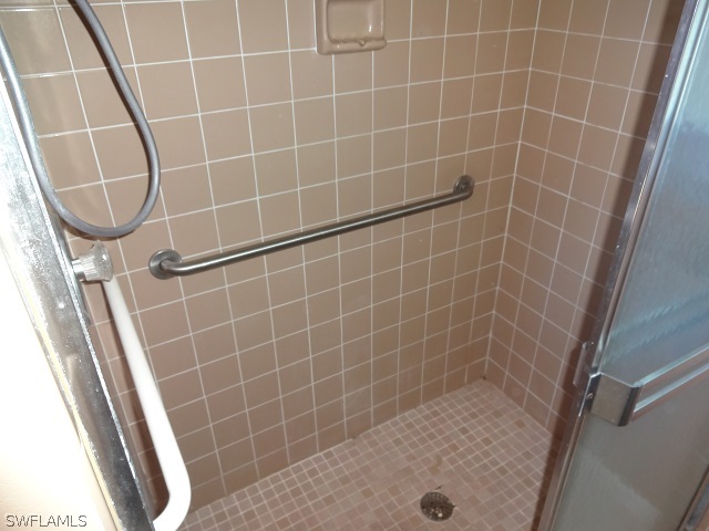 17537 Laurel Valley Road Fort Myers, FL 33967 - Photo 11 of 16 a bathroom with a glass door shower