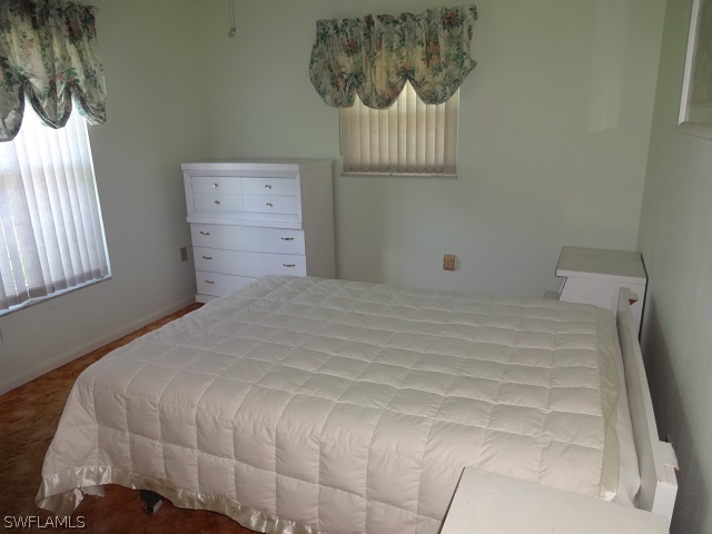 17537 Laurel Valley Road Fort Myers, FL 33967 - Photo 5 of 16 a bedroom with a bed and a window