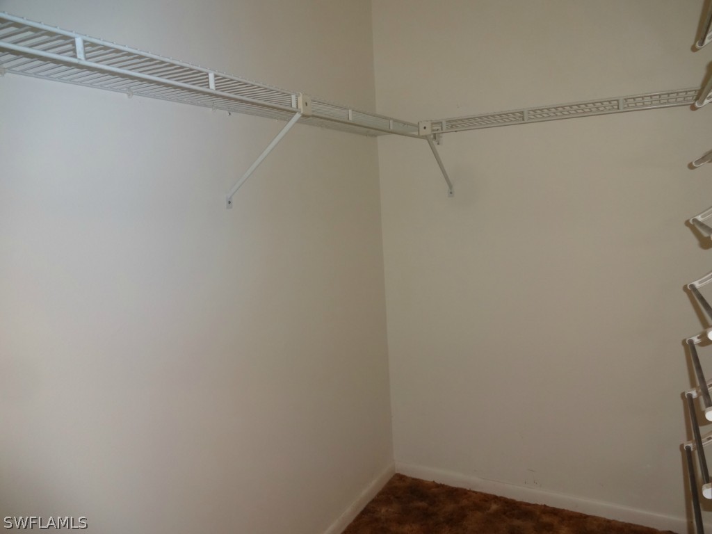17537 Laurel Valley Road Fort Myers, FL 33967 - Photo 8 of 16 a view of a room with racks on the wall