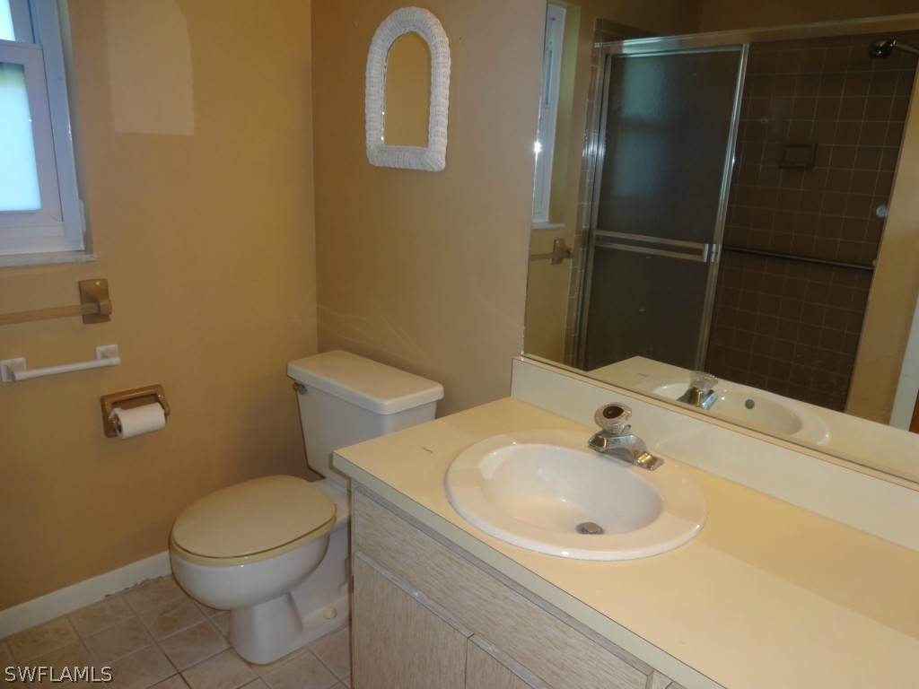 17537 Laurel Valley Road Fort Myers, FL 33967 - Photo 10 of 16 a bathroom with a sink and a toilet