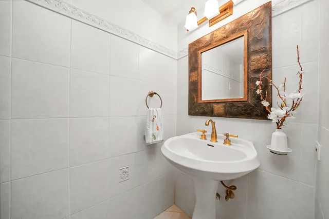 a bathroom with a sink a toilet and mirror