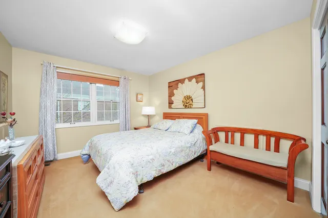 a bed sitting in a bedroom next to a window