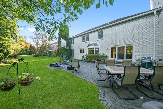 a view of a house with backyard sitting area and garden