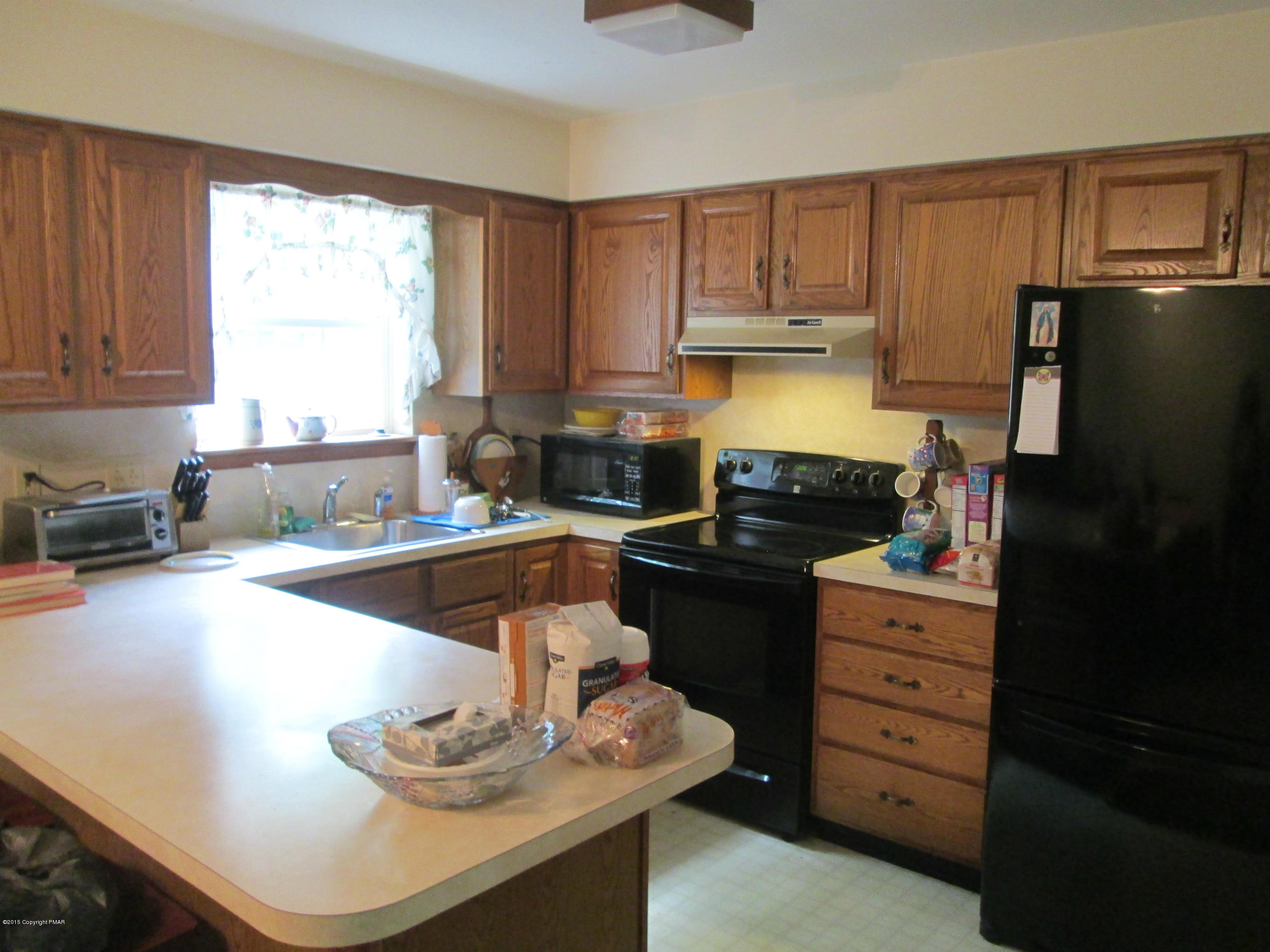 187 Shenkel Road Effort, PA 18330 - Photo 3 of 6 a kitchen with granite countertop a refrigerator stove and sink