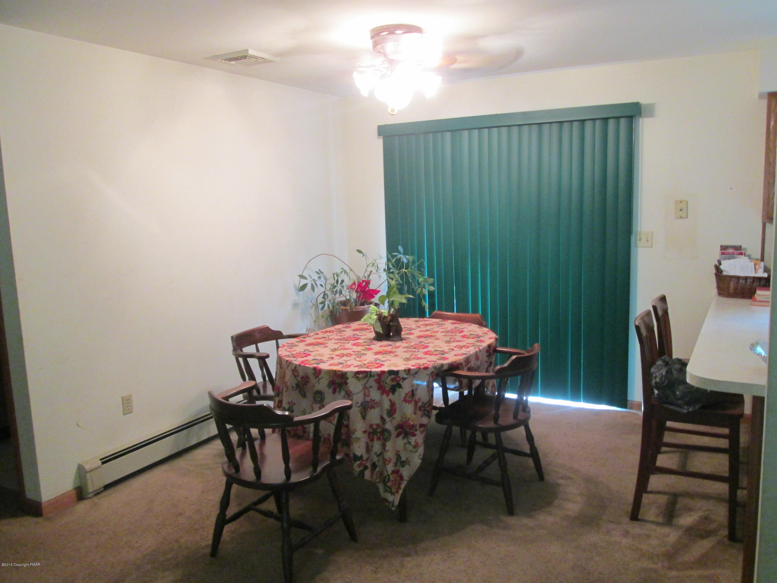 187 Shenkel Road Effort, PA 18330 - Photo 4 of 6 a dining room with furniture a chandelier and wooden floor