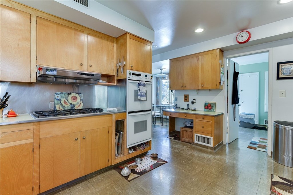 2000 Braeburn Road Altadena, CA 91001 - Photo 16 of 46 a kitchen with stainless steel appliances granite countertop a stove a sink and a refrigerator