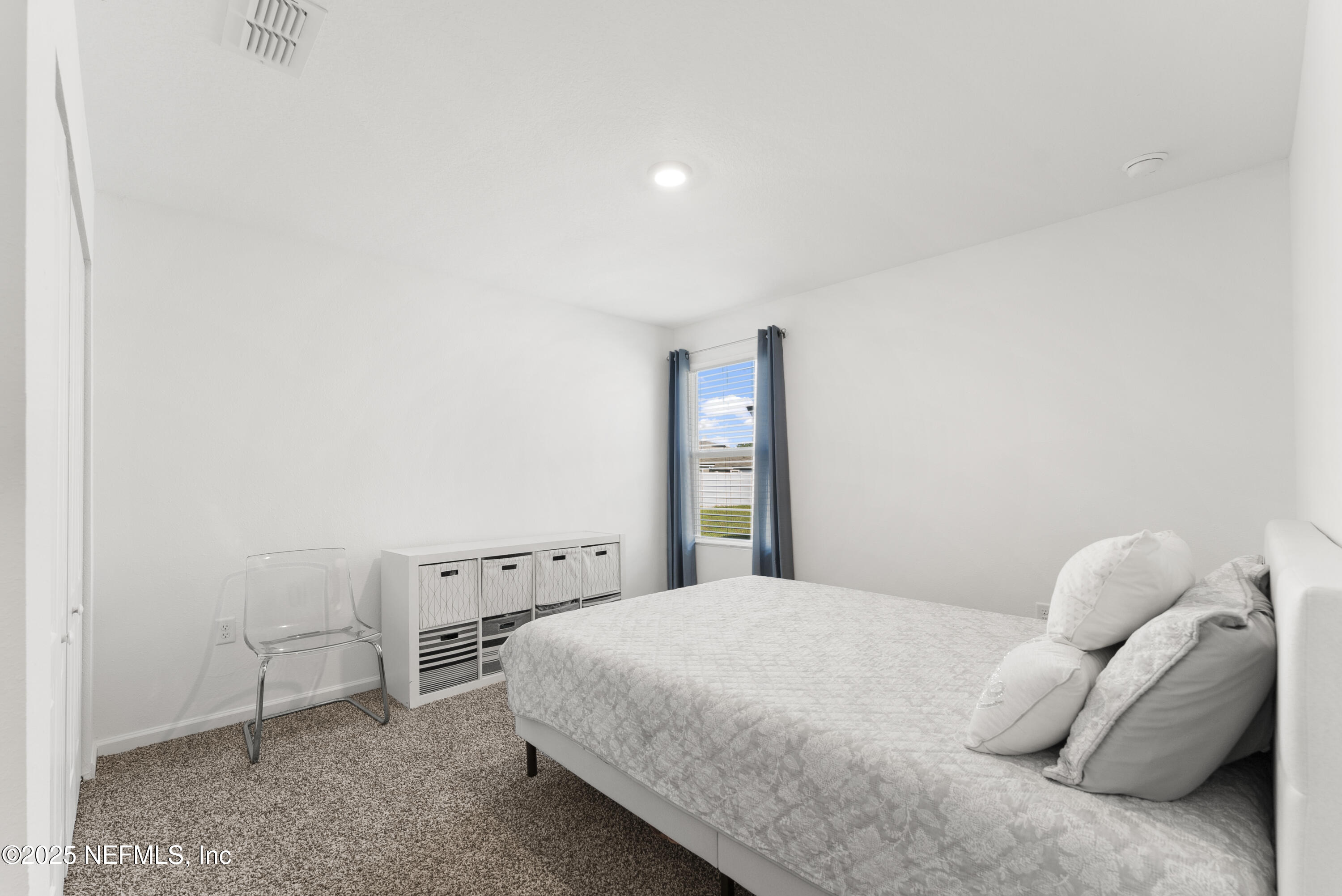 12698 Cucumber Tree Street Jacksonville, FL 32218 - Photo 13 of 26 a bedroom with a bed and a window