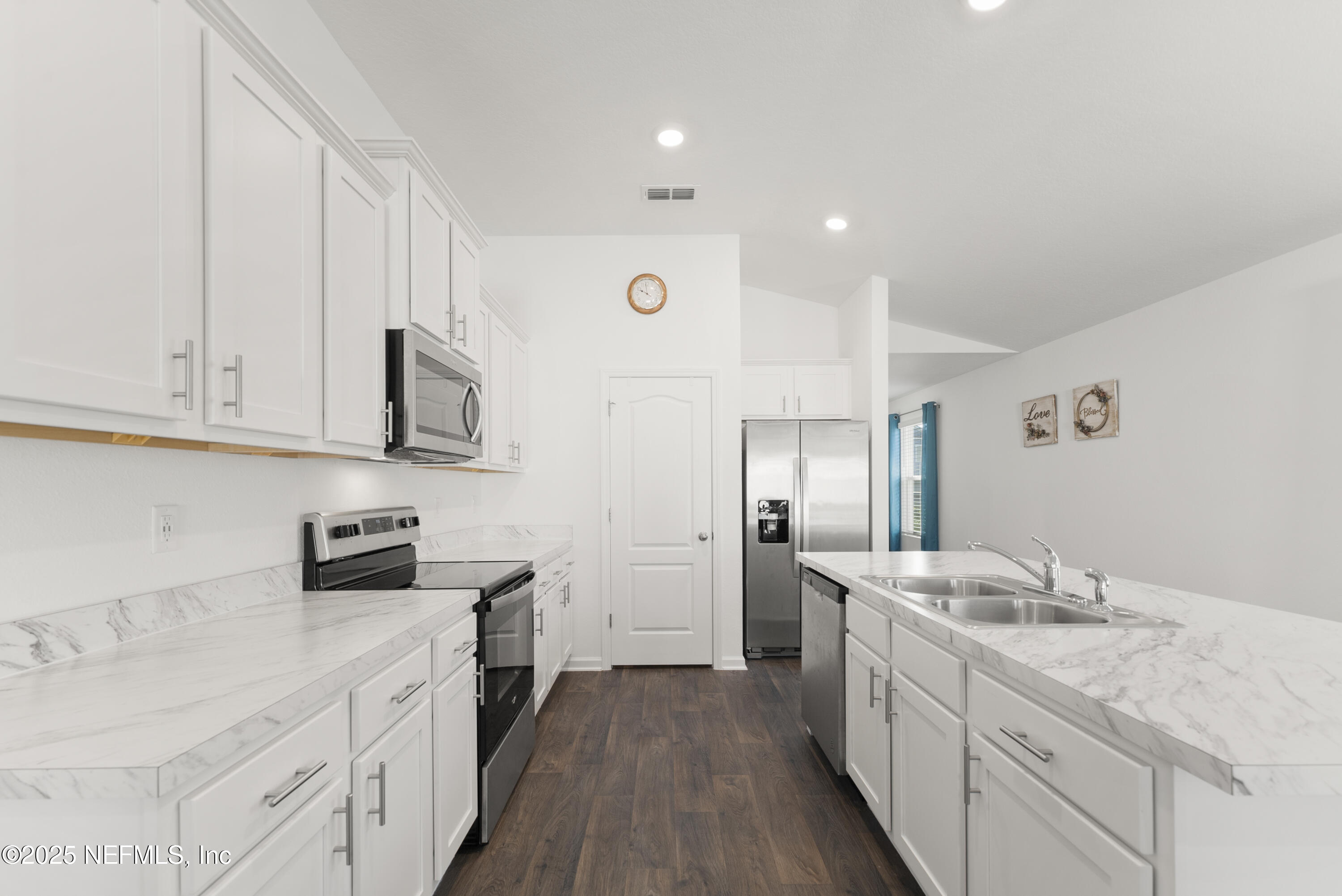 12698 Cucumber Tree Street Jacksonville, FL 32218 - Photo 5 of 26 a kitchen with granite countertop white cabinets and stainless steel appliances