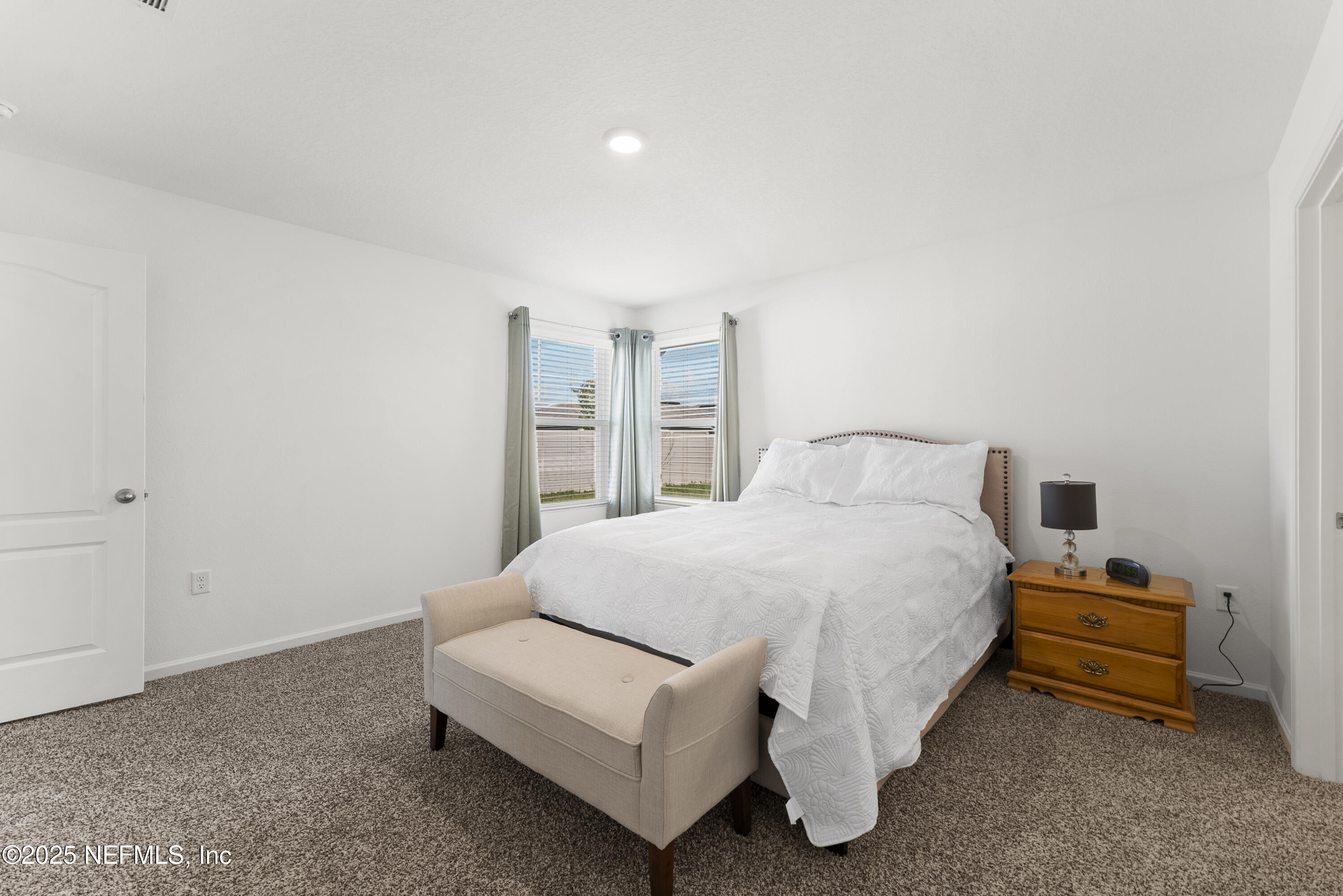 12698 Cucumber Tree Street Jacksonville, FL 32218 - Photo 8 of 26 a spacious bedroom with a bed and a window