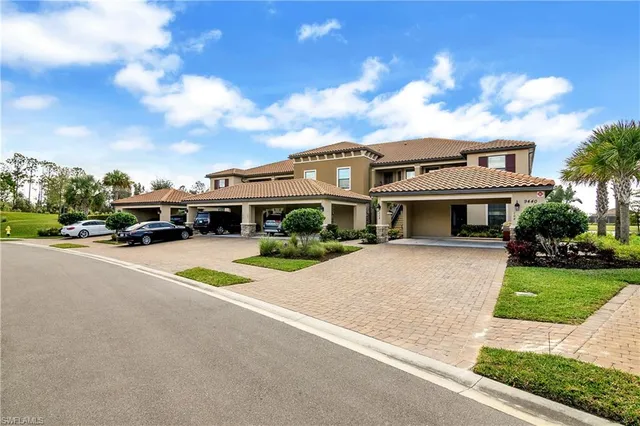a front view of a house with a garden and yard