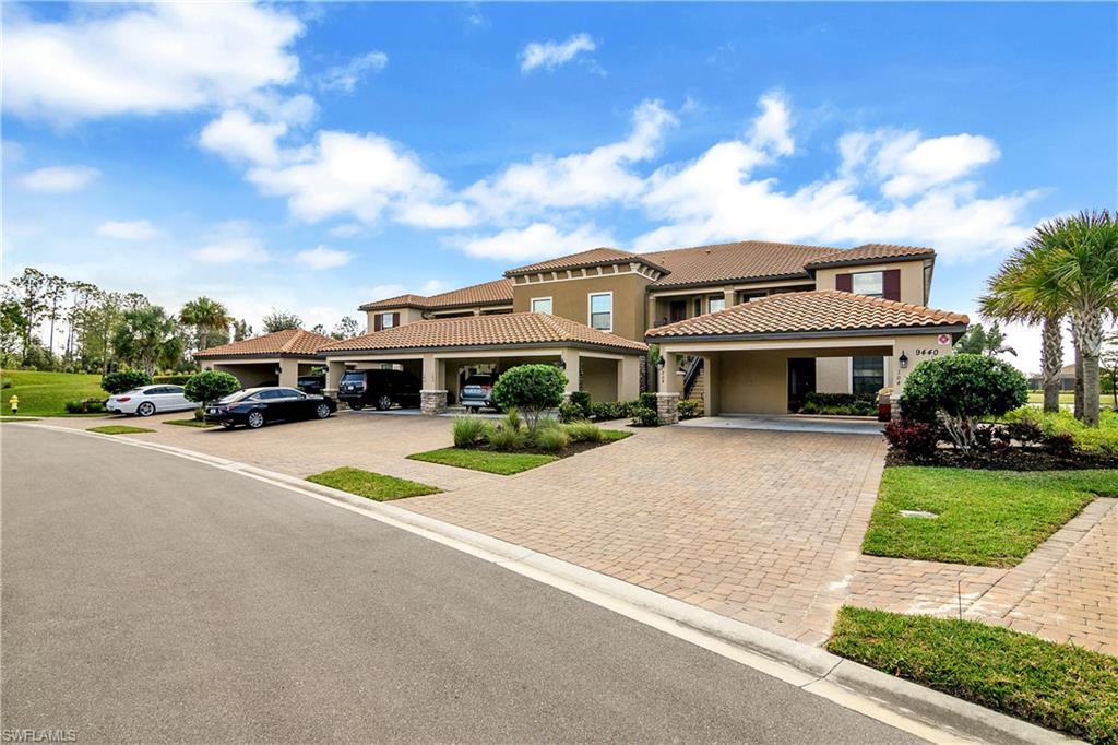 9440 Benvenuto Court, Unit 3204 Naples, FL 34119 - Photo 14 of 28 a front view of a house with a garden and yard